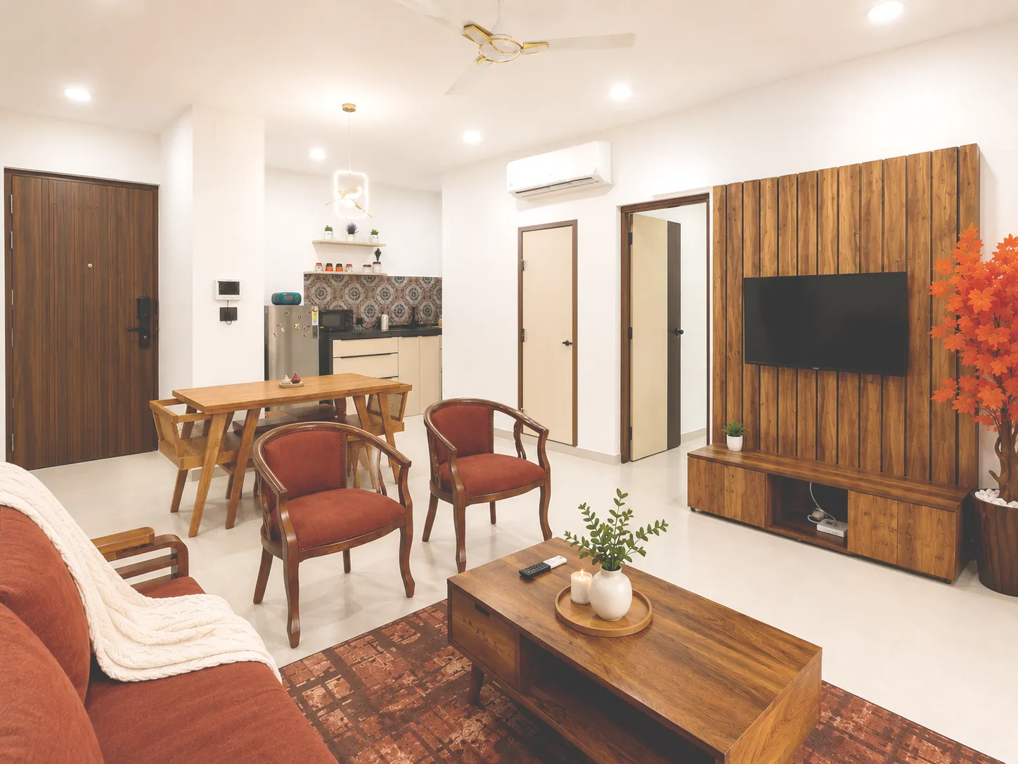 Spacious air-conditioned living and dining room with wood furniture, terracotta chairs and Smart TV